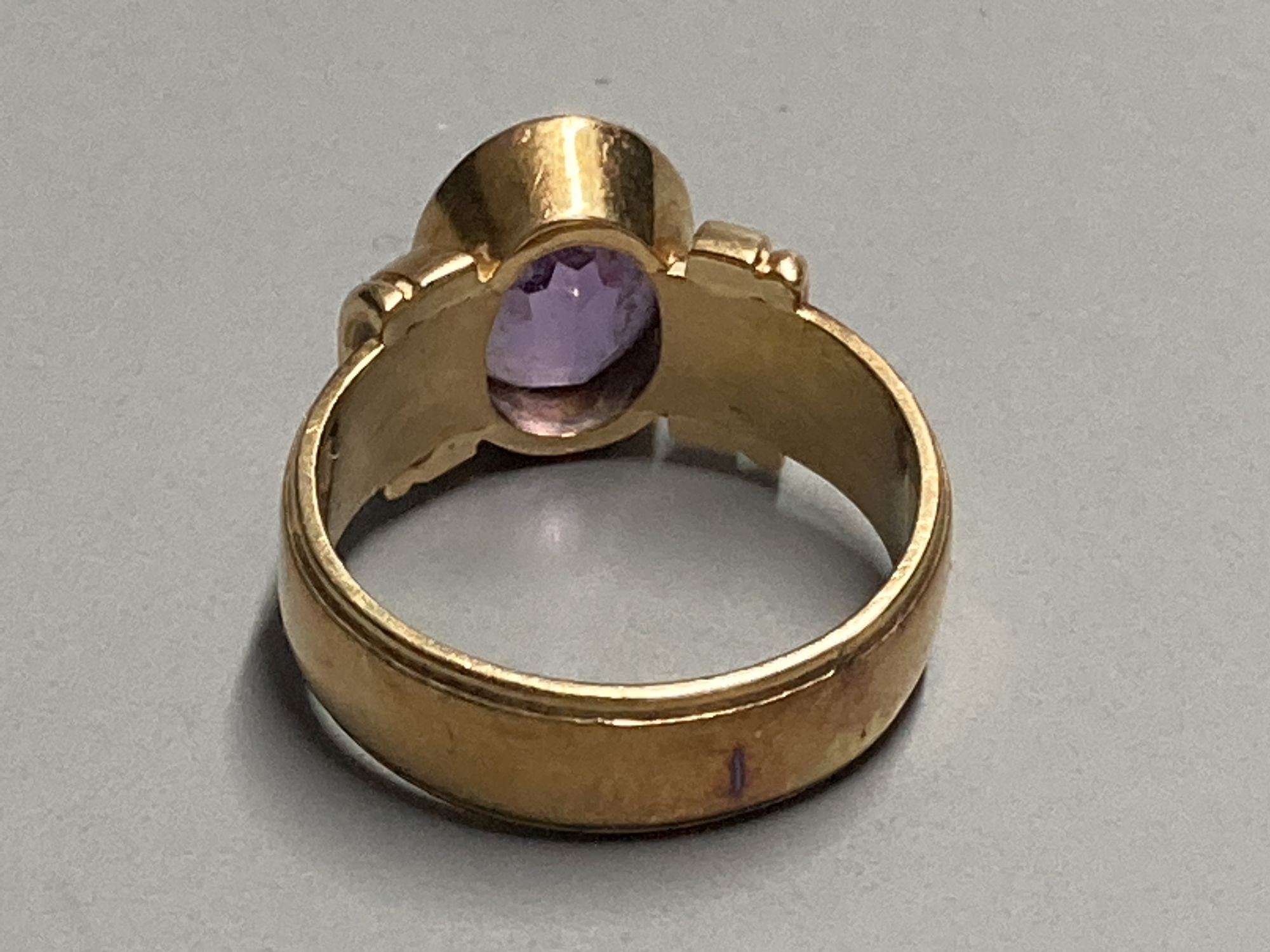 A 1950s? 585 yellow metal and amethyst set dress ring, size K, gross 7.3 grams.